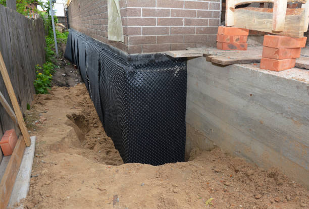 Happy homeowners after waterproofing job in Harlan